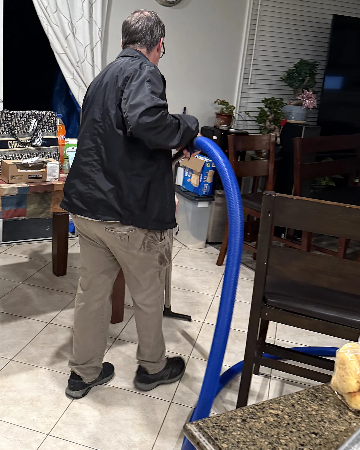 Flood-Pro technician extracting water from a kitchen tile floor at a Cerritos job